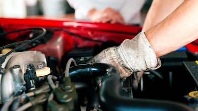 car-mechanic-working-on-a-car-engine