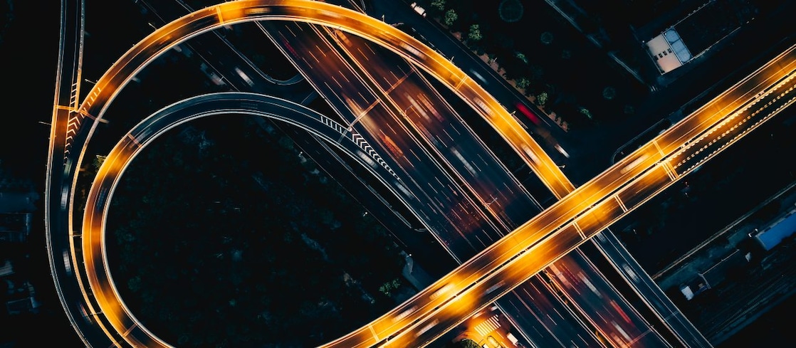 Night highway from above with light streaks