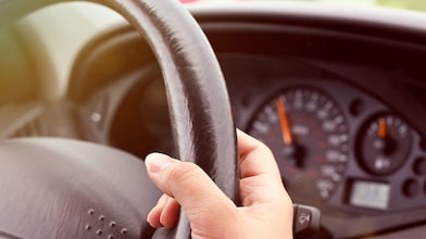 hand-holding-steering-wheel