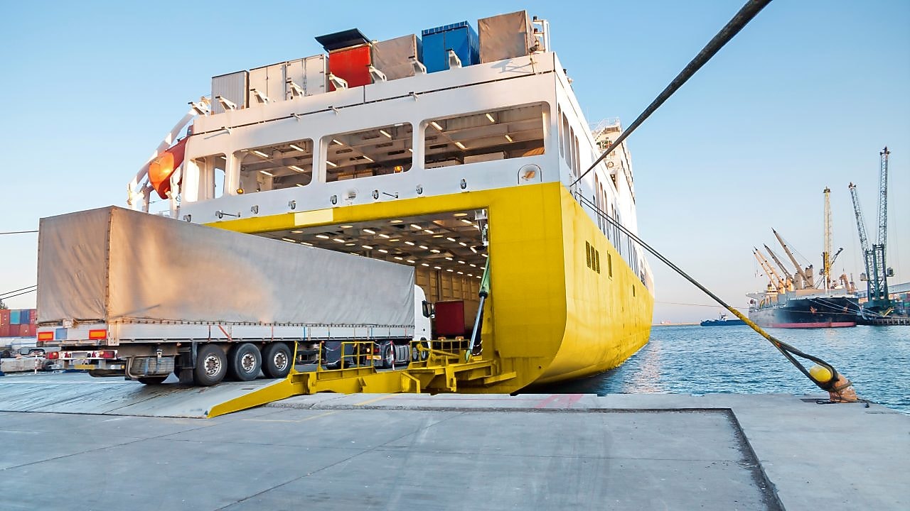 Large truck being loaded onto a ferry