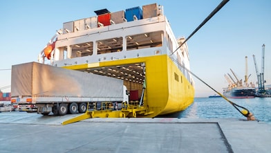 Large truck being loaded onto a ferry