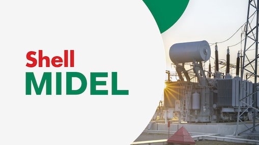 Un transformateur au coucher du soleil. Les mots "Shell MIDEL" sont affichés à gauche sur un fond gris clair.