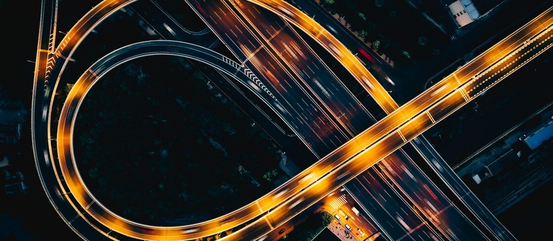 Night highway from above with light streaks