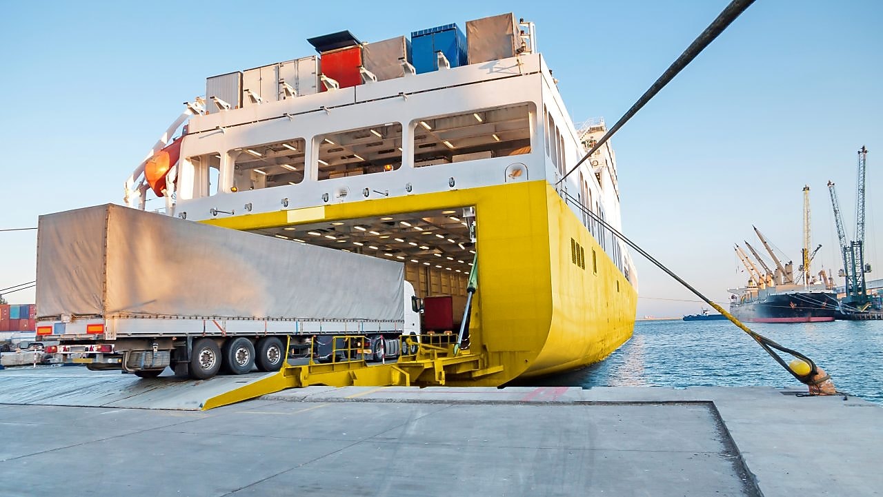 Large truck being loaded onto a ferry