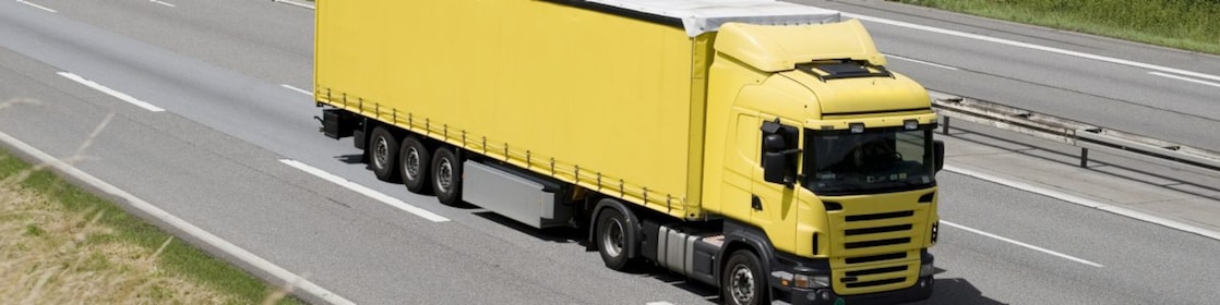 Blue sky over yellow truck on a highway