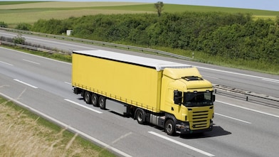 Blue sky over yellow truck on a highway
