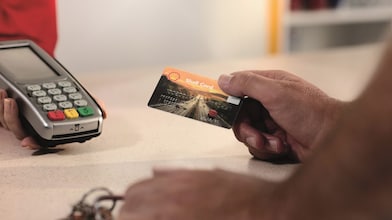 de mens te voegen euroShell kaart in de gokautomaat