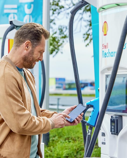 Man at shell recharge charge station